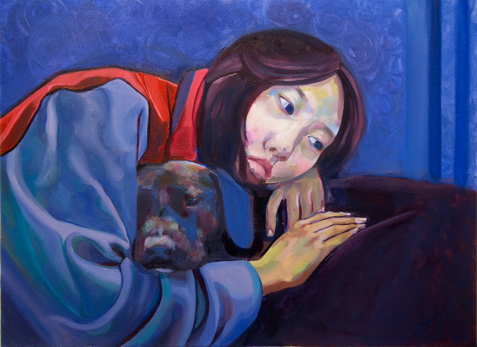 A person in a blue jacket reclining beside a dark dog against a vivid blue background.